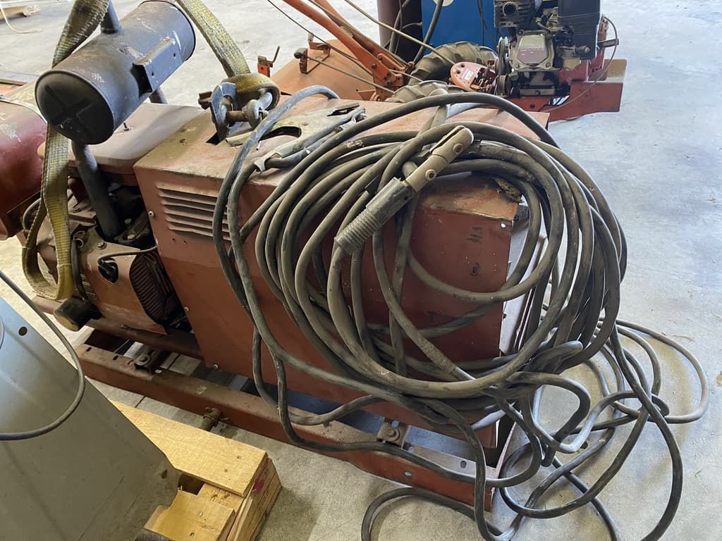 A welding machine with a lot of wires attached to it.