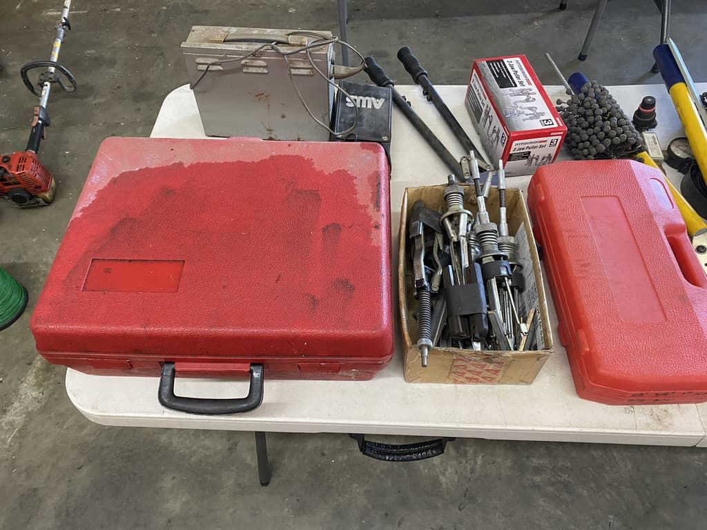 A table with tools and a red case on it