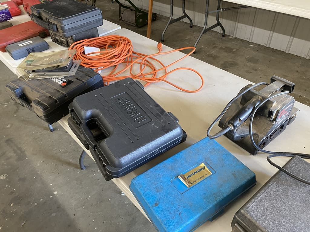 A table with a bunch of tools and cases on it.