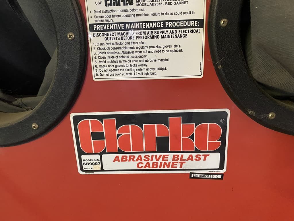 A clarke abrasive blast cabinet with instructions on how to use it