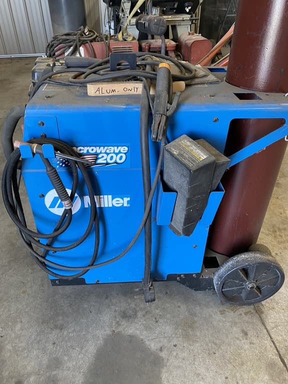 A miller welding machine is sitting on the ground