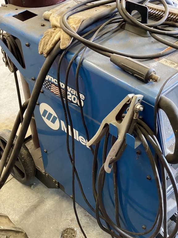 A miller welding machine with a pair of gloves on it