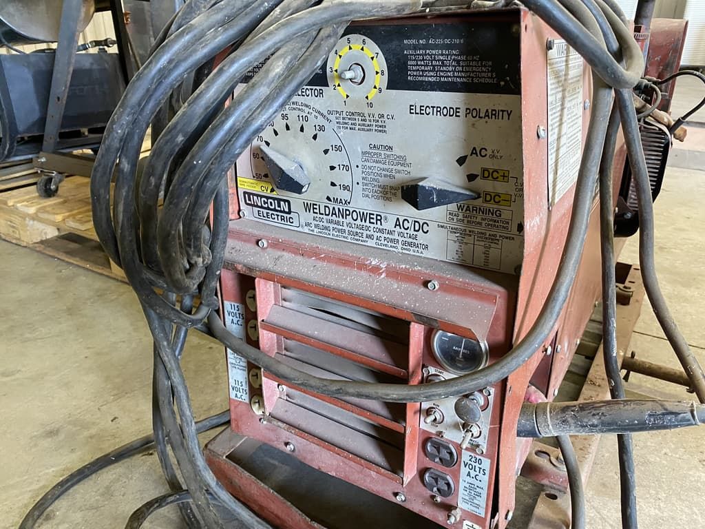 A welding machine with a lot of wires attached to it.