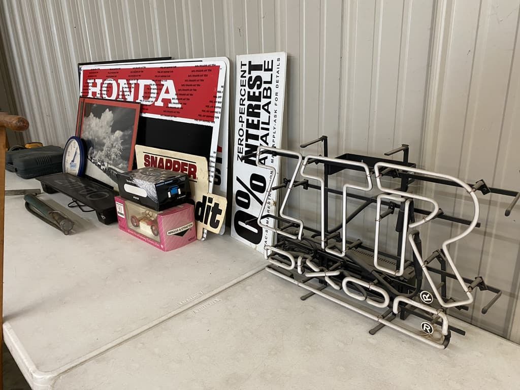 A table with a lot of signs on it including a neon sign that says r on it.