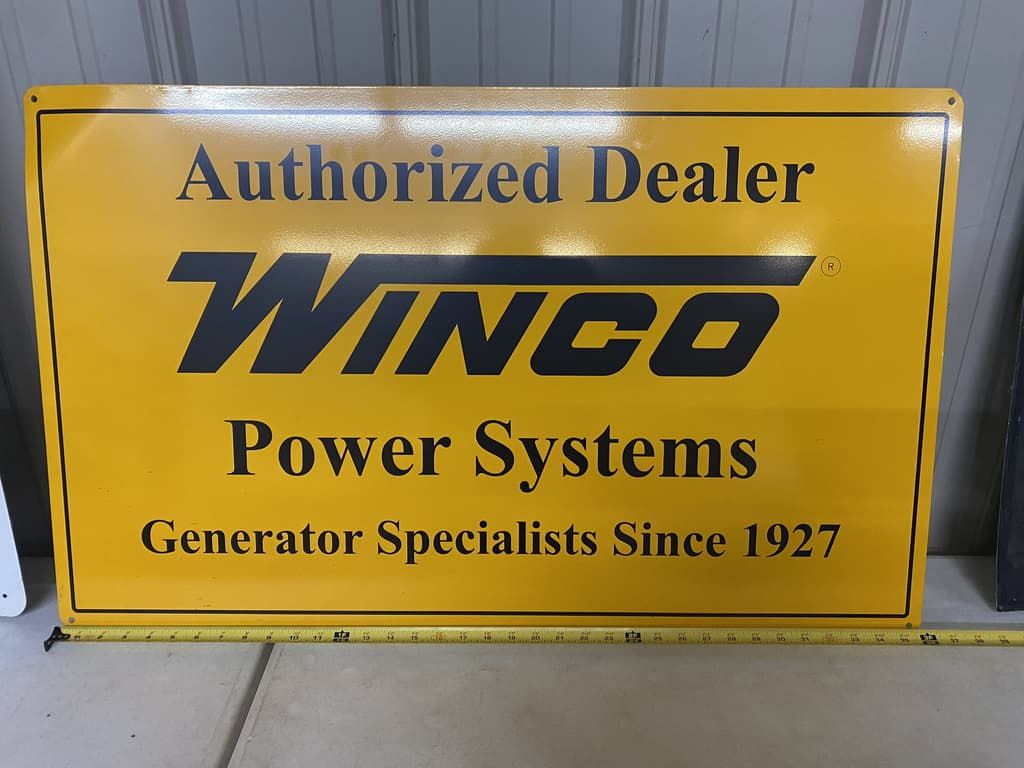 A yellow sign that says authorized dealer winco power systems generator specialists since 1927