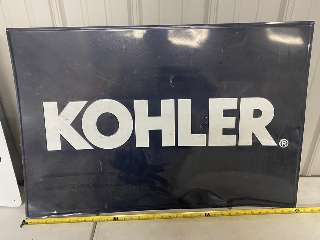 A kohler sign is sitting next to a measuring tape