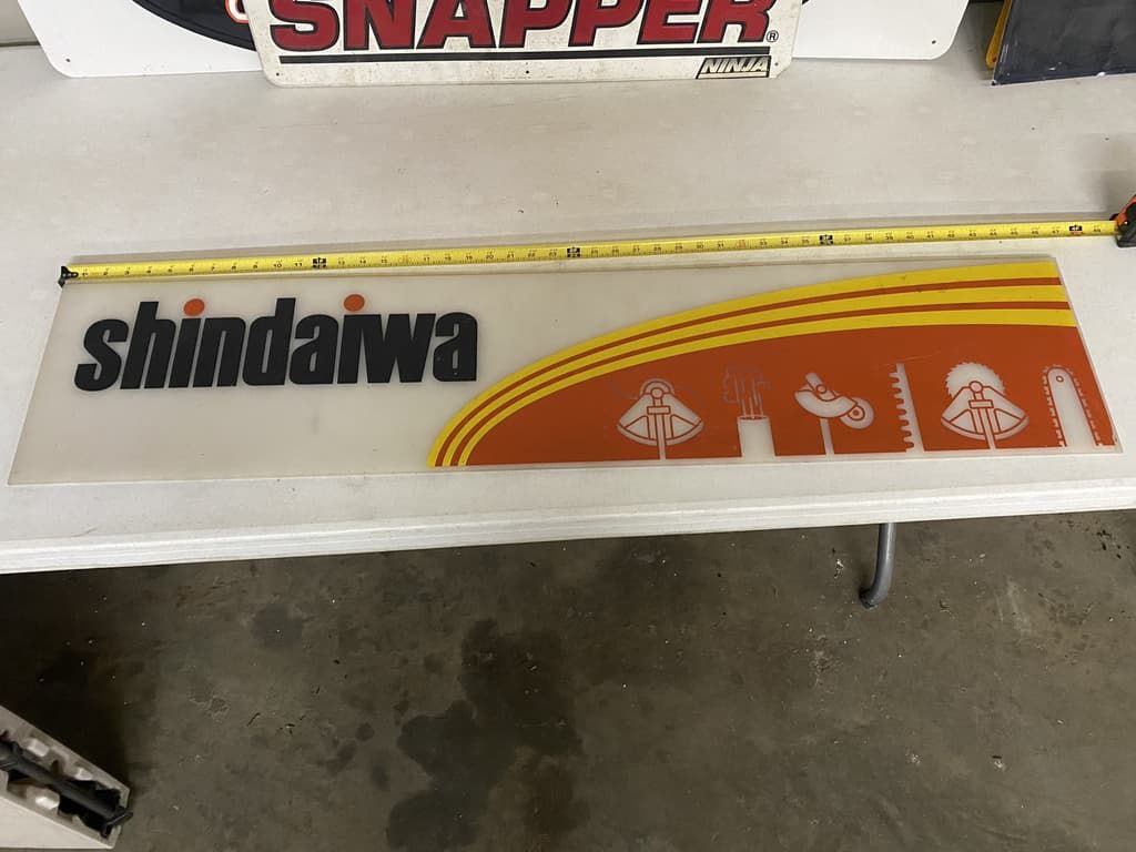 A white table with a sign that says shindaiwa on it