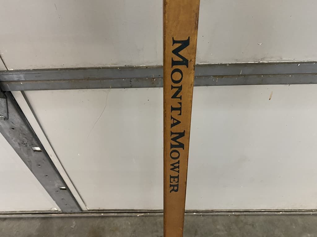 A wooden stick that says montamower on it