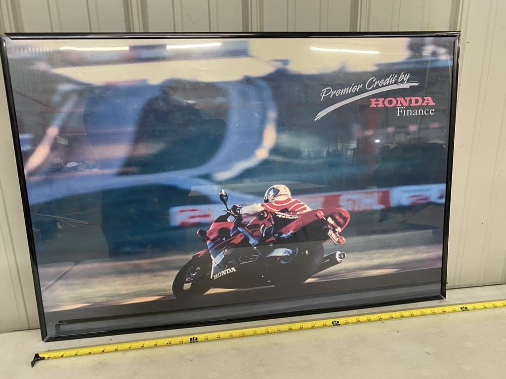 A picture of a man riding a motorcycle with the word honda on it