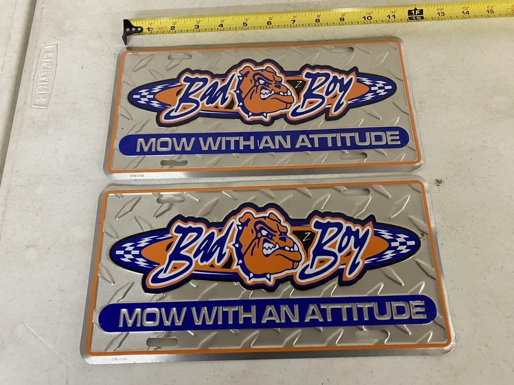 Two lawn mower stickers that say mow with an attitude