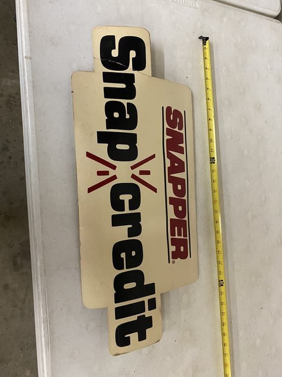 A snap credit sign sits next to a tape measure