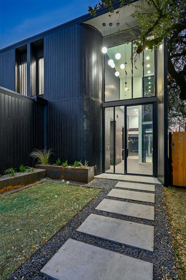 A black house with a walkway leading to it