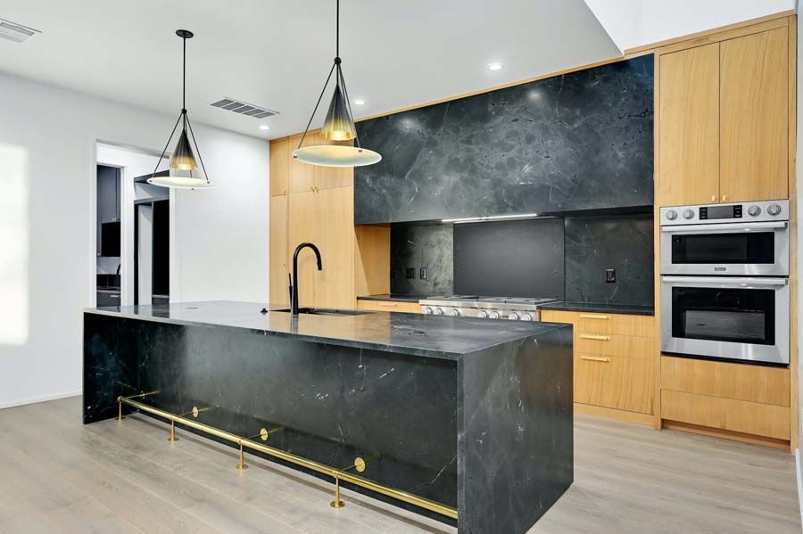 A kitchen with a large island and stainless steel appliances.
