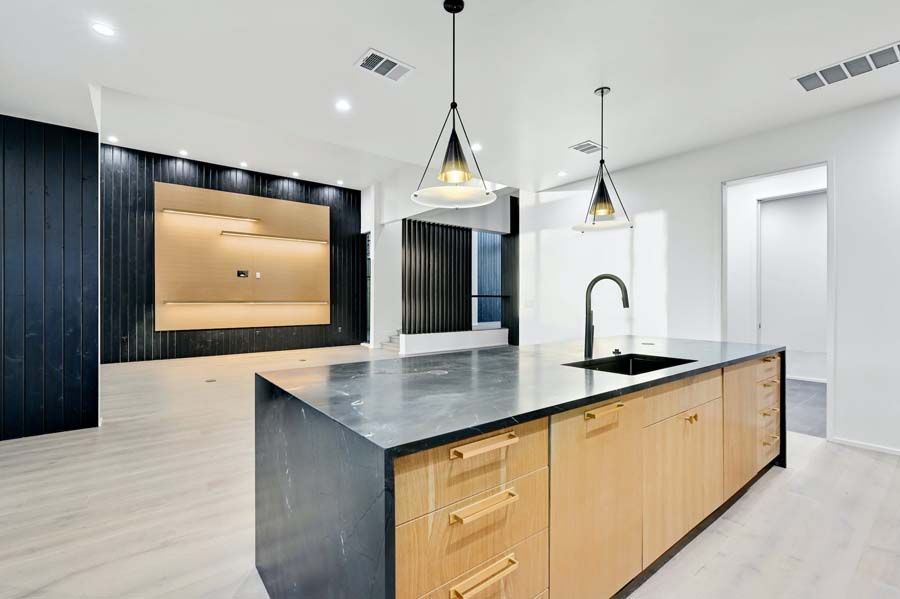 A kitchen with a large island and a sink.