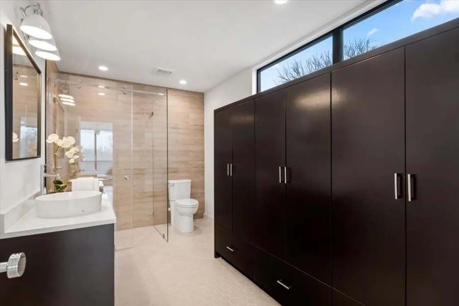 A bathroom with a sink , toilet , and walk in shower.