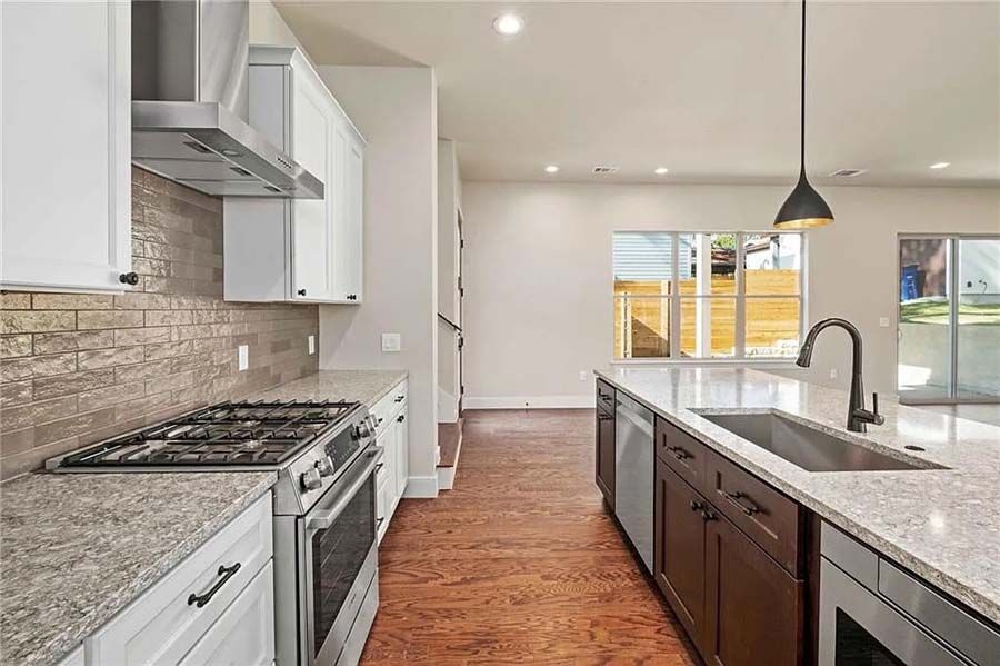A kitchen with stainless steel appliances and granite counter tops.