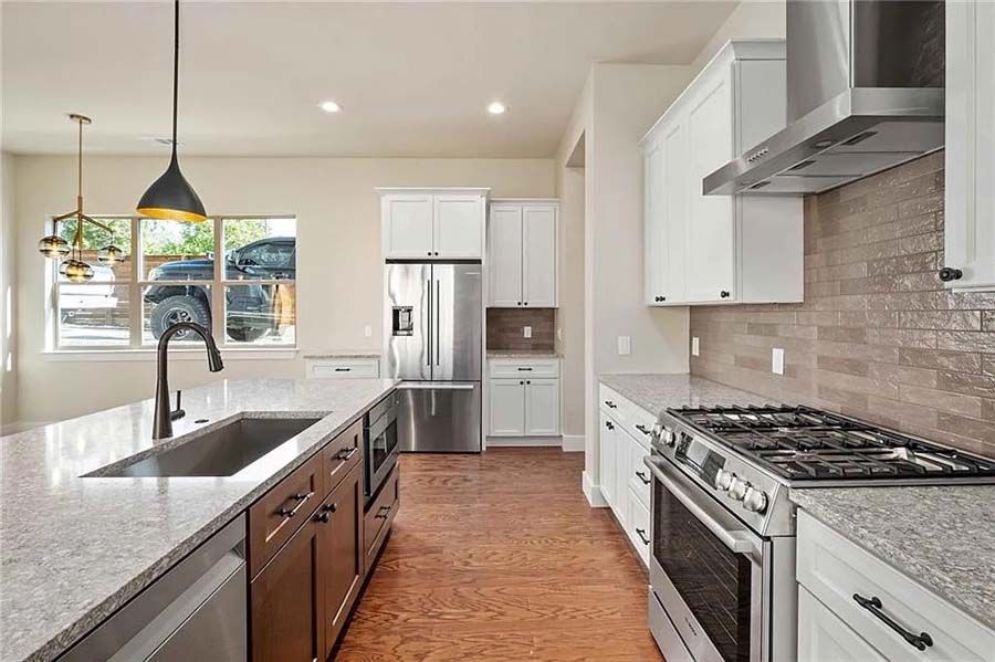 A kitchen with stainless steel appliances and granite counter tops.