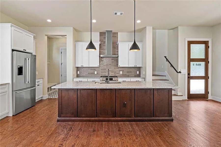 There is a large island in the middle of the kitchen.