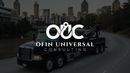 Black tow truck on a road with city skyline in the background, OUC logo on the truck.