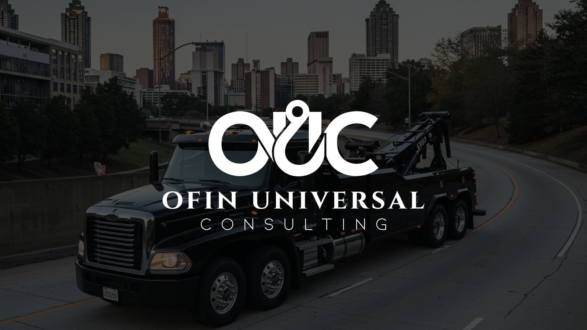 Black tow truck on a road with city skyline in the background, OUC logo on the truck.