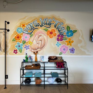 There is a mural of a baby in the womb on the wall.