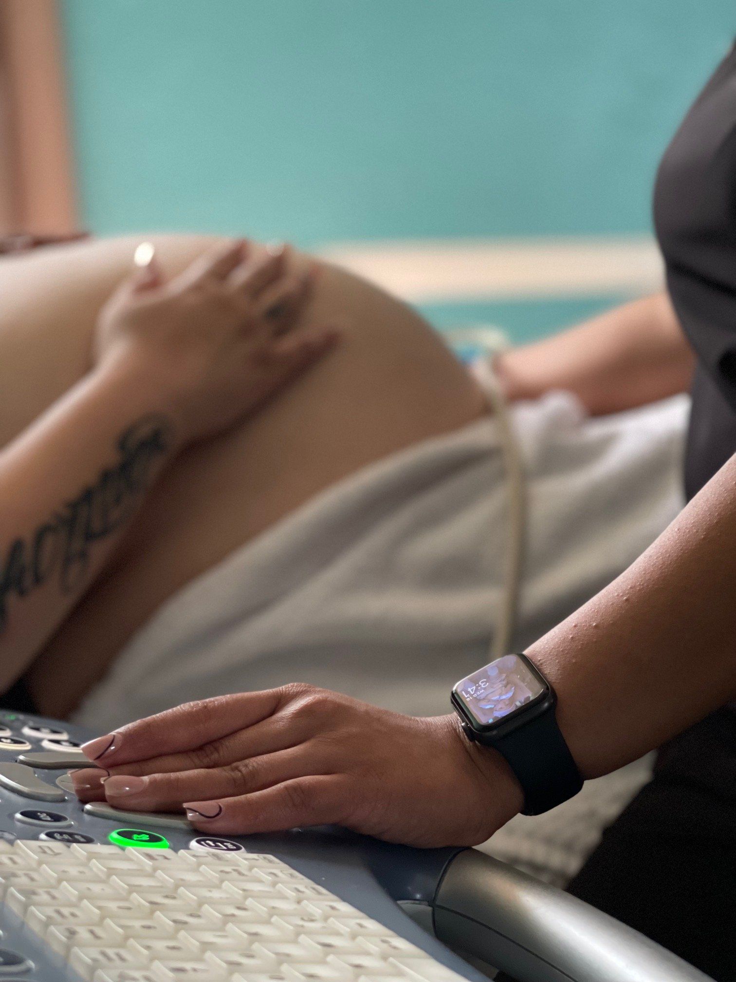 A pregnant woman is getting an ultrasound from a doctor