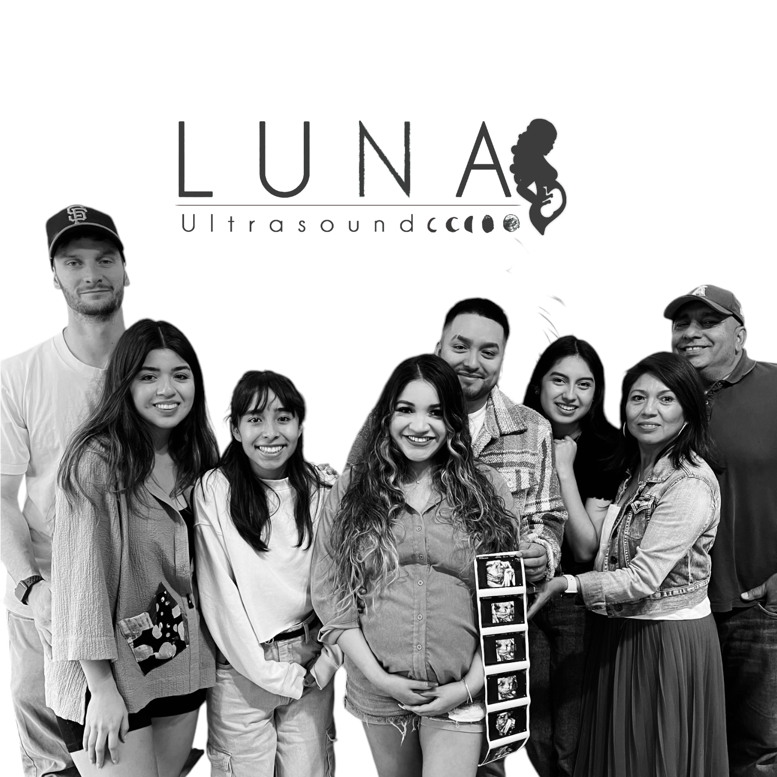 A black and white photo of a family standing next to each other.