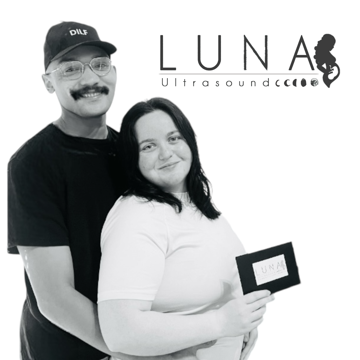 A black and white photo of a man and woman with luna ultrasound in the background