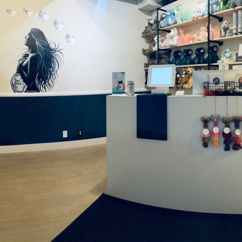 A woman with long hair is painted on the wall behind the counter