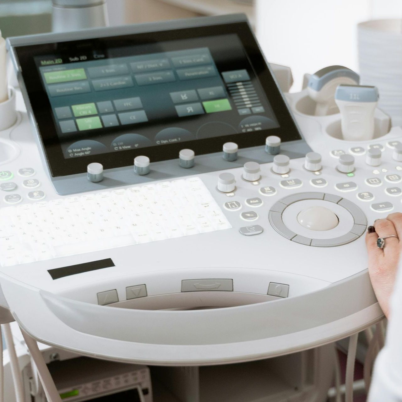 A person is using an ultrasound machine with a large screen