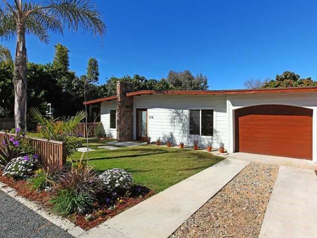 A white house with a red garage door