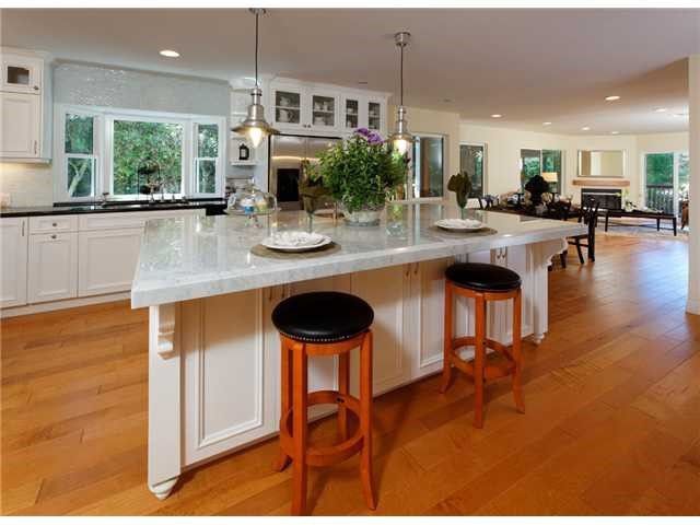 A kitchen with a large island and stools in Encinitas, Southern California.