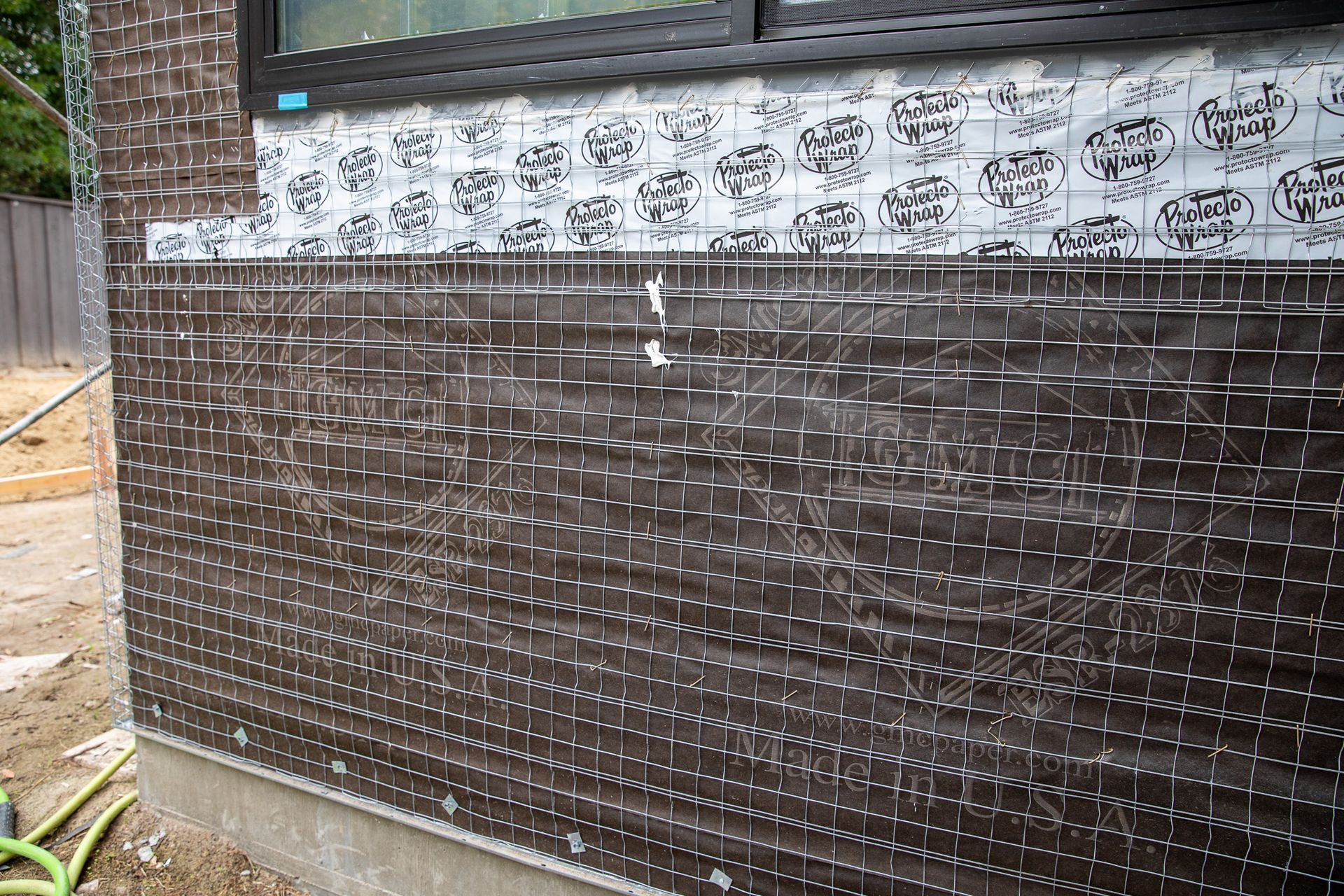 A brick wall with a lot of holes in it is being built.