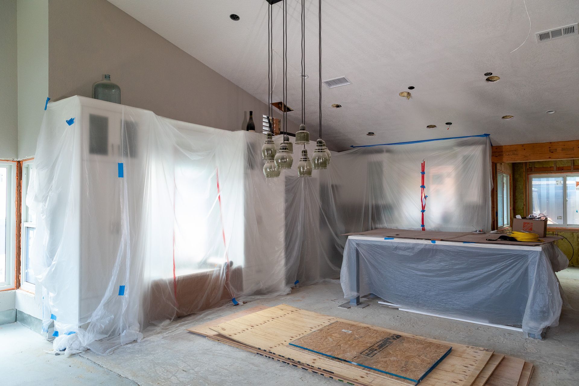 A house is being remodeled and covered in plastic.