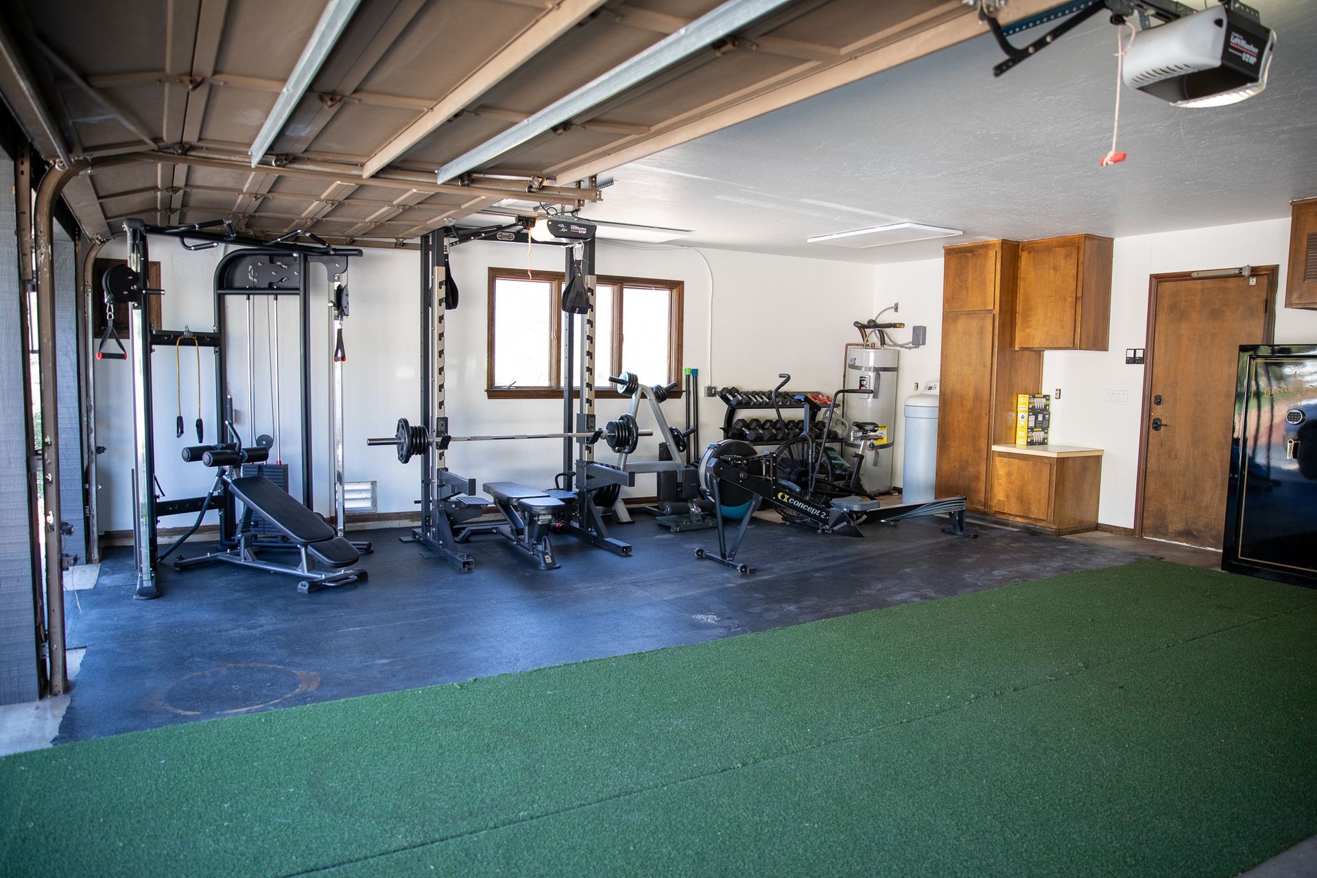 A garage with a lot of exercise equipment in it