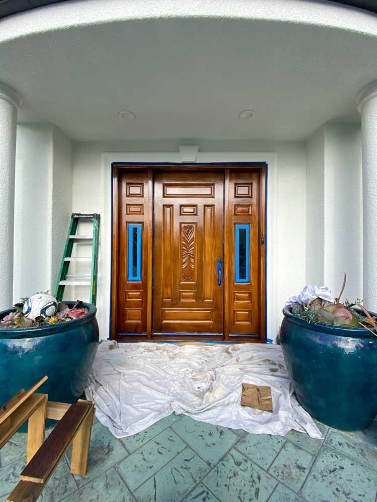 The front door of a house is being painted.