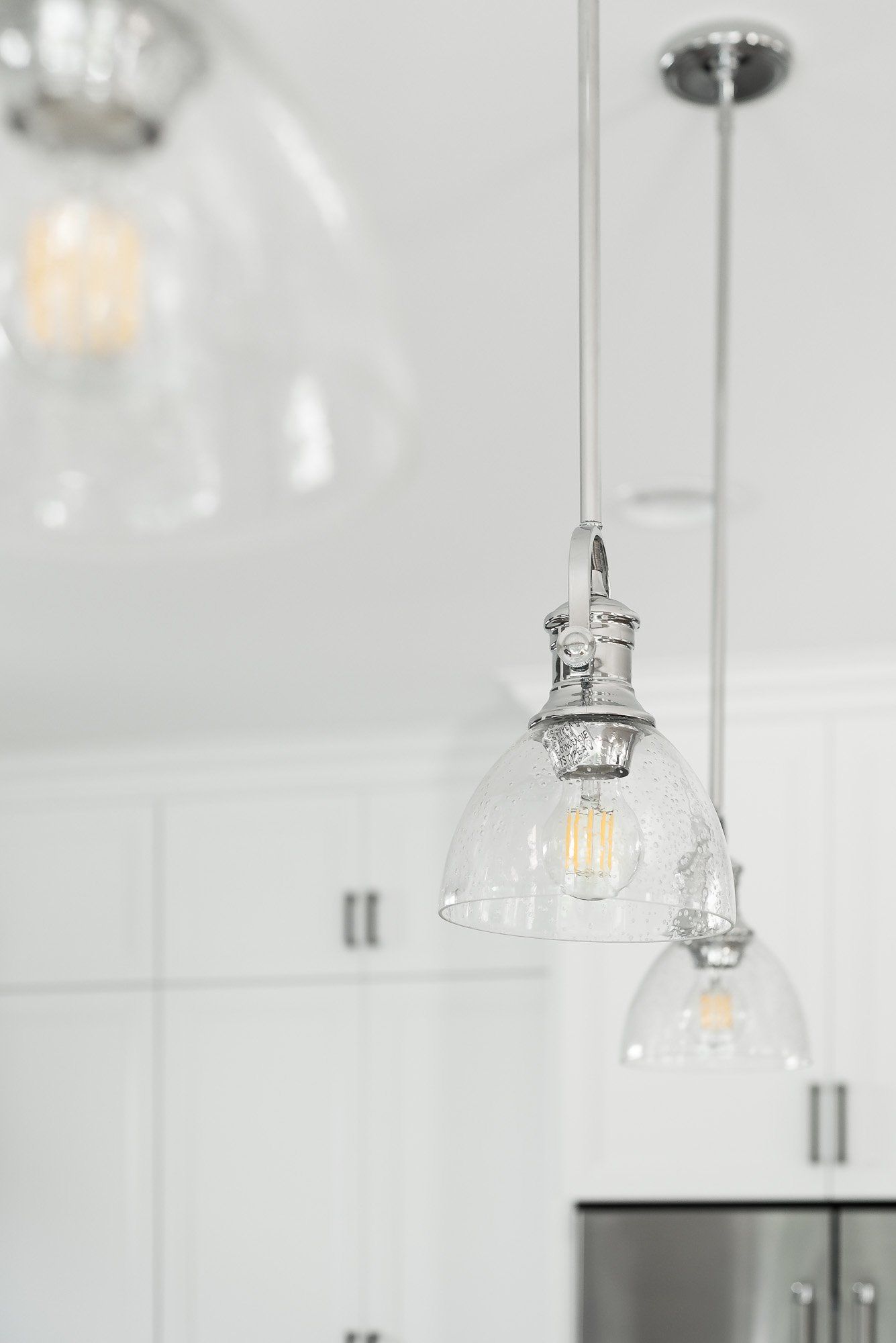 A kitchen with a lot of pendant lights hanging from the ceiling.