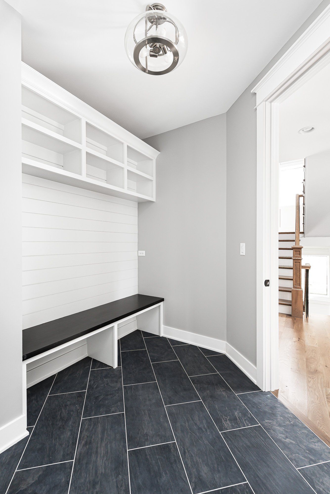 There is a bench in the corner of the room.