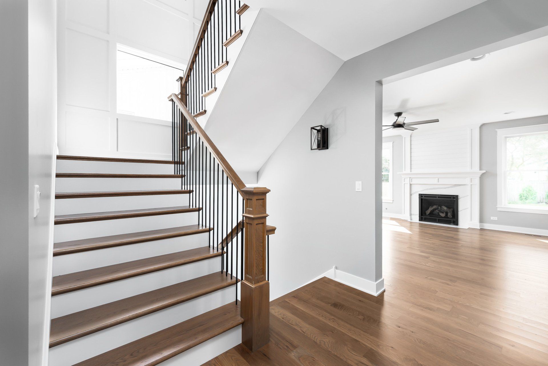 An empty house with a staircase leading up to the second floor.
