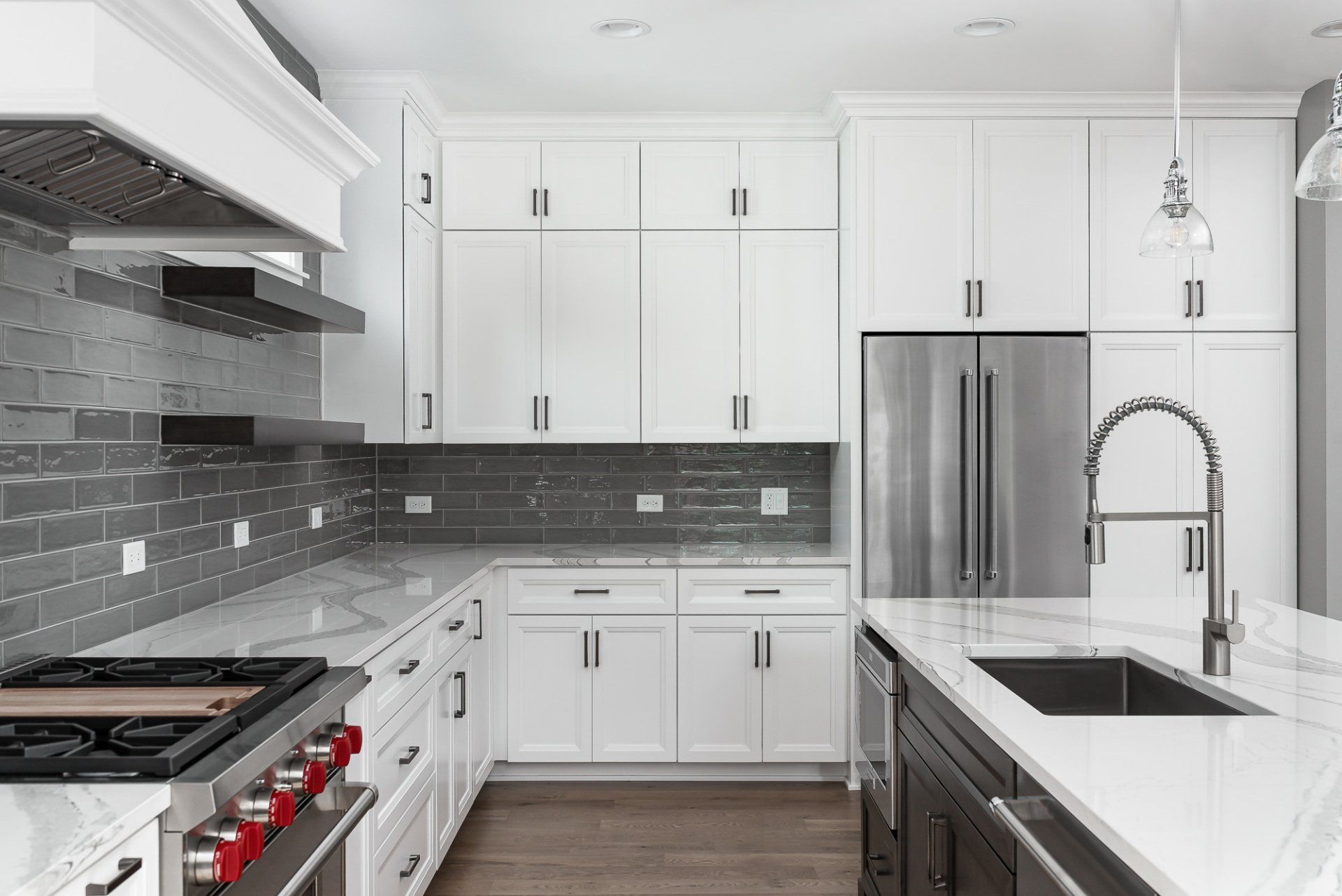 A kitchen with white cabinets and stainless steel appliances.