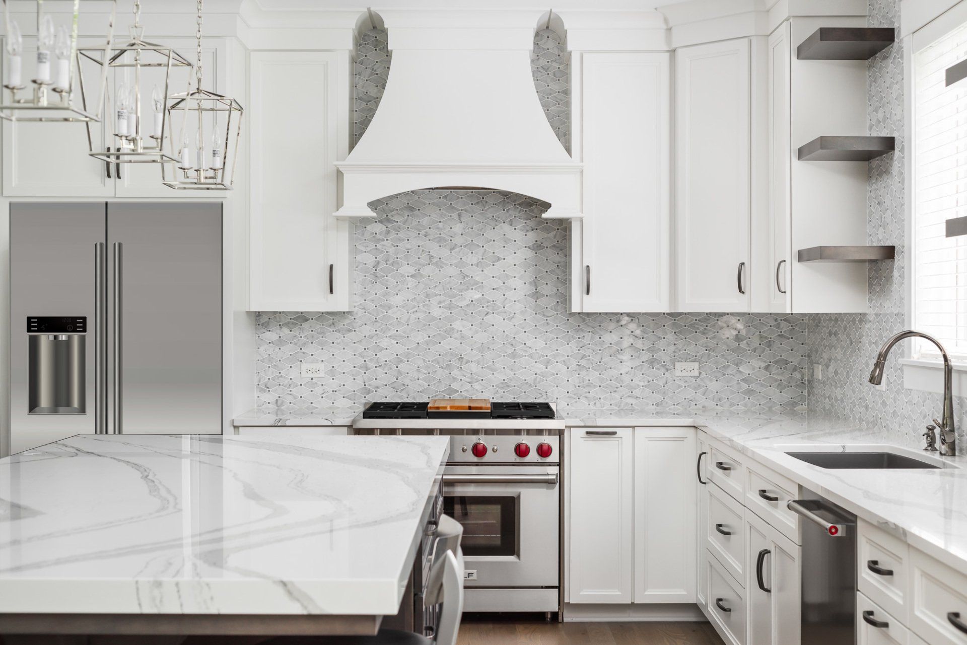 A kitchen with white cabinets and stainless steel appliances.