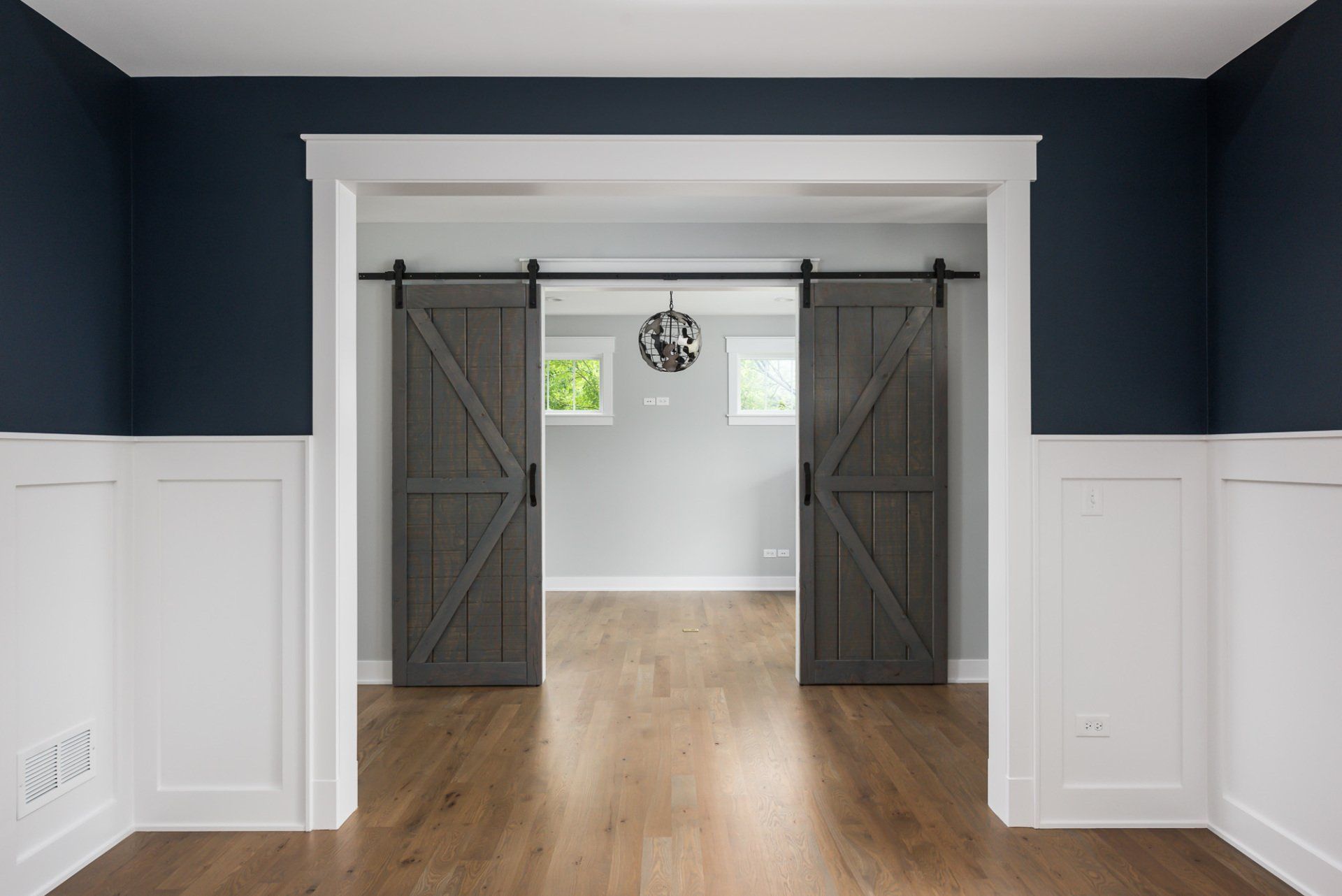 There are two sliding barn doors in the middle of the room.