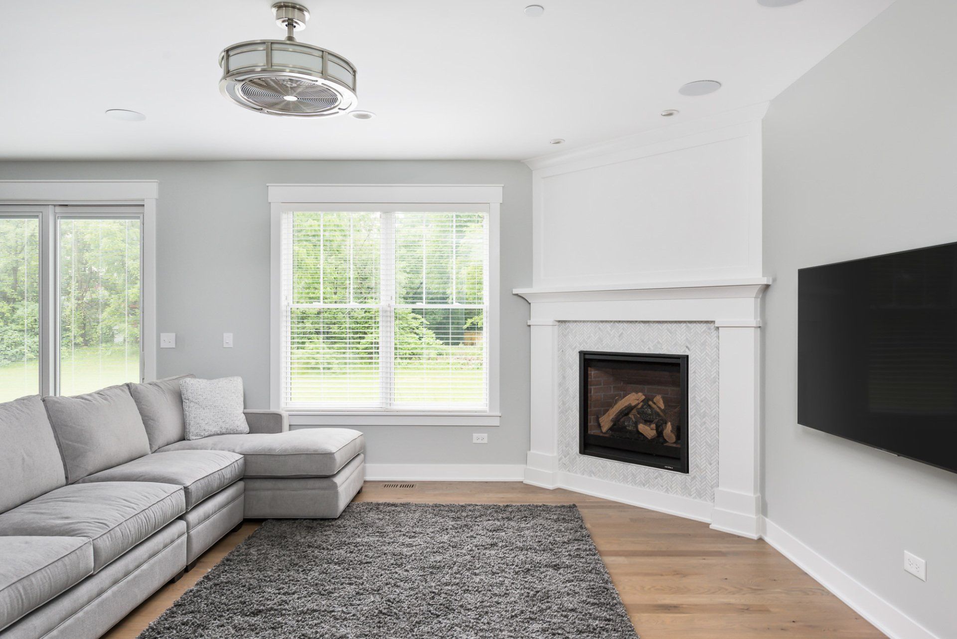 A living room with a couch , fireplace and television.