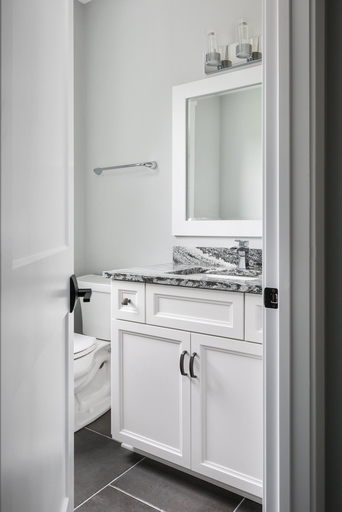 A bathroom with a sink , toilet and mirror.