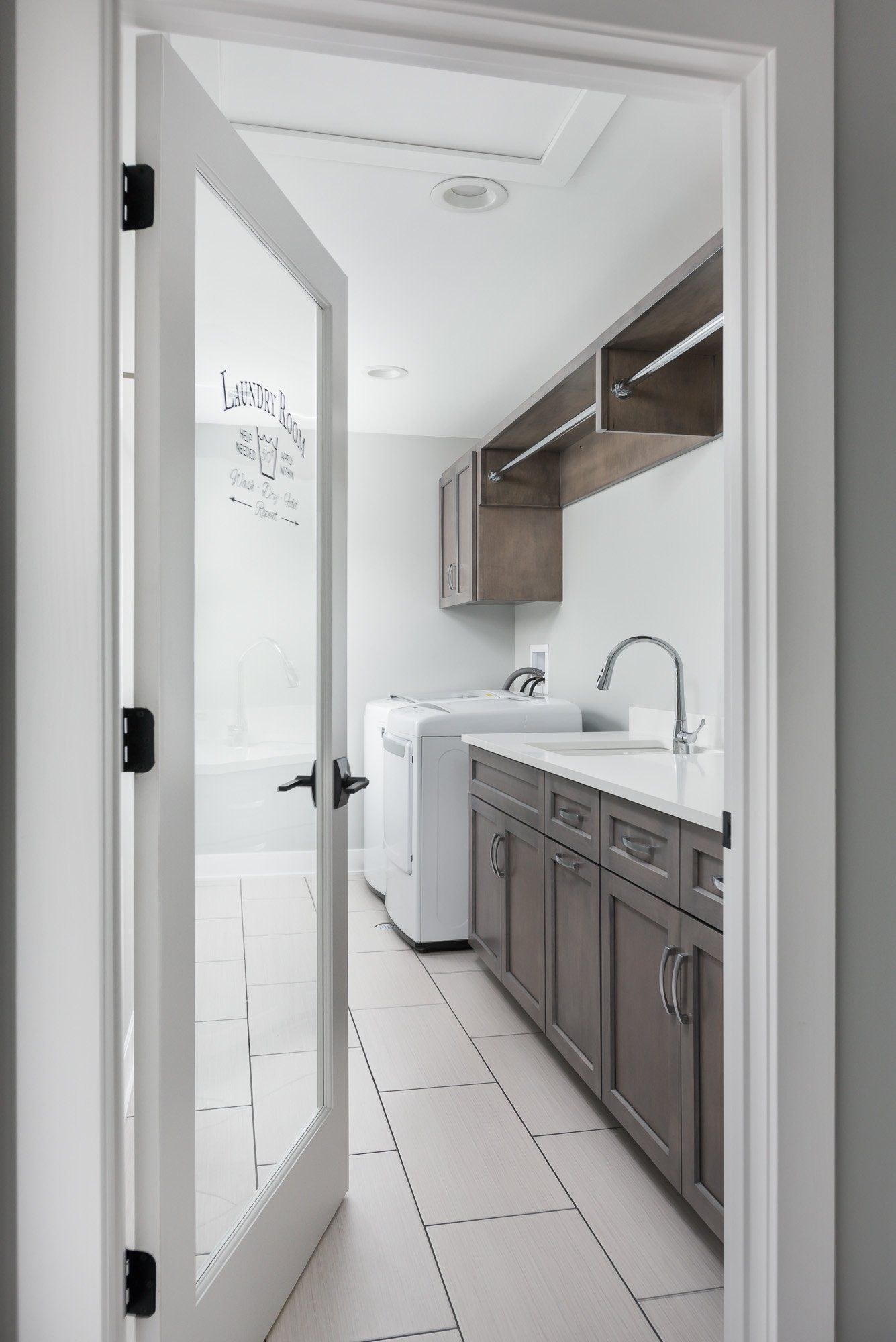 A laundry room with a washer and dryer and a sink.