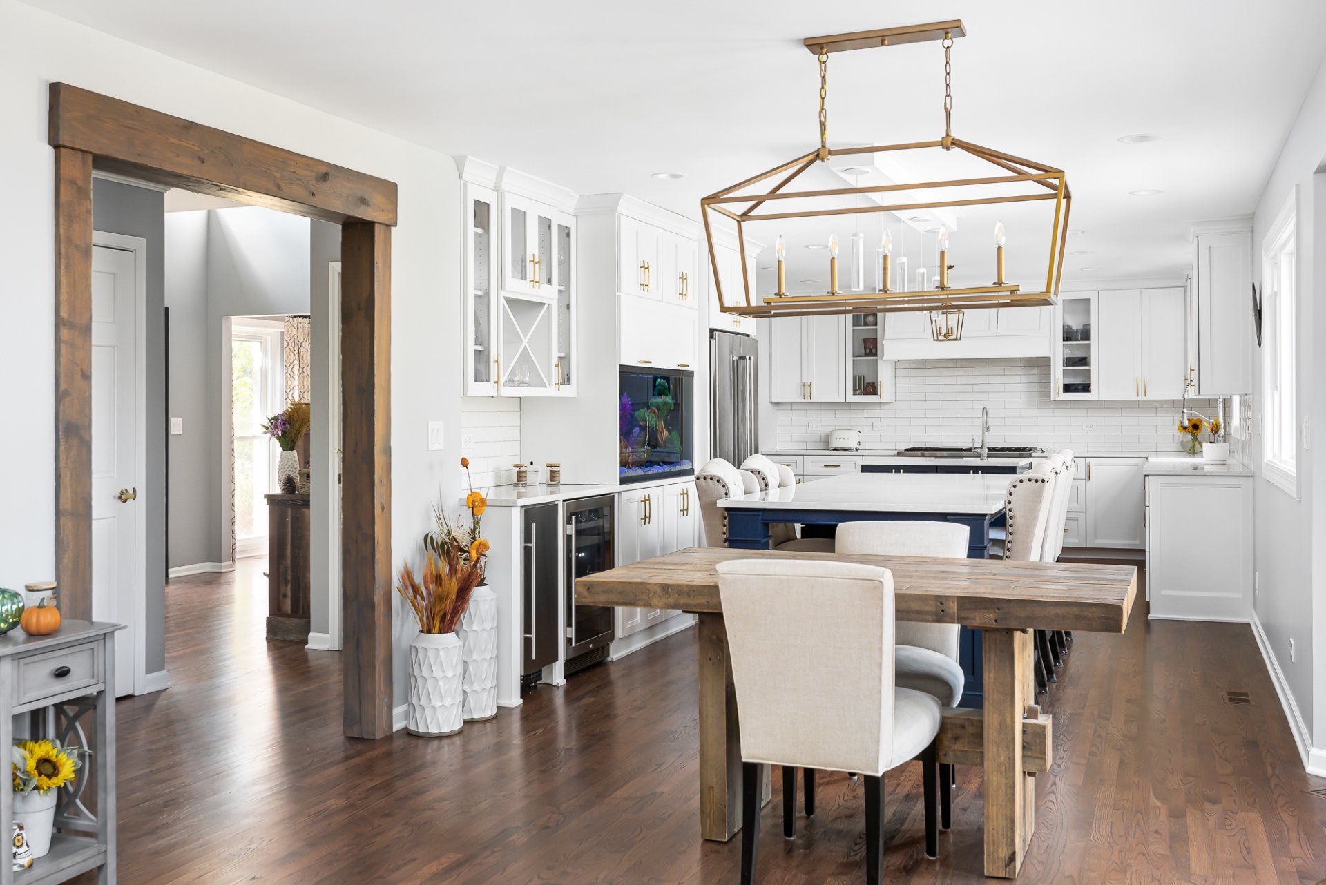 A kitchen and dining room in a house with a wooden table and chairs.