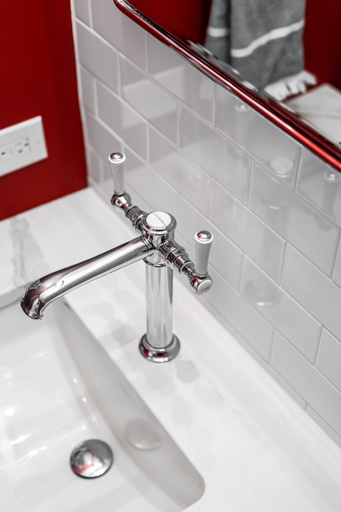 A bathroom sink with a faucet and a mirror.