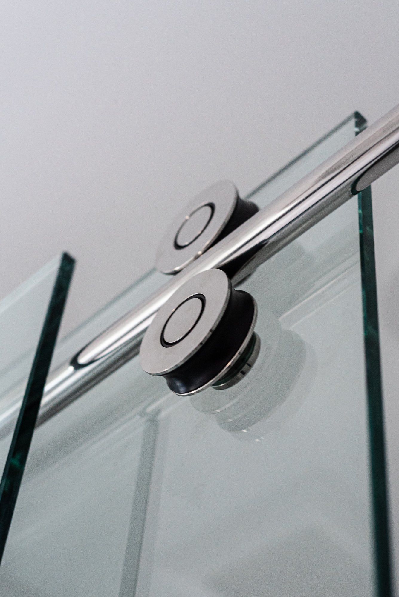 A close up of a sliding glass door with a metal railing.