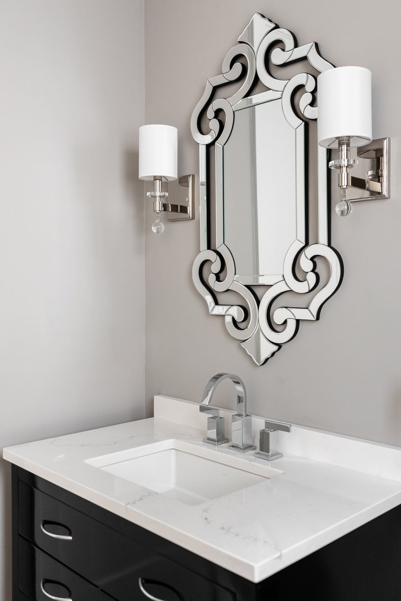 A bathroom with a sink and a mirror on the wall.