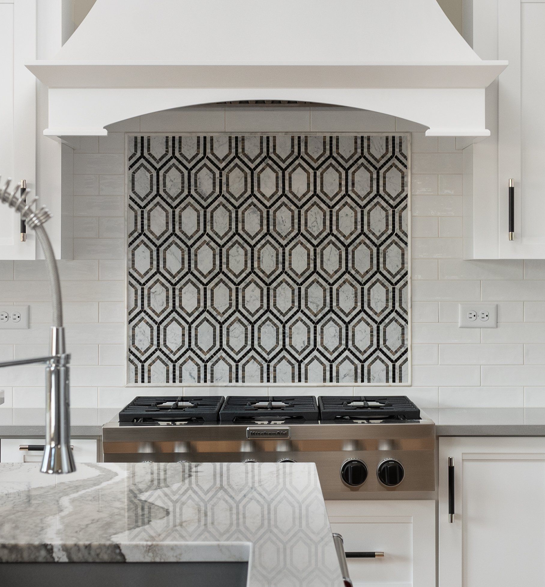 A kitchen with a stove top oven and a sink